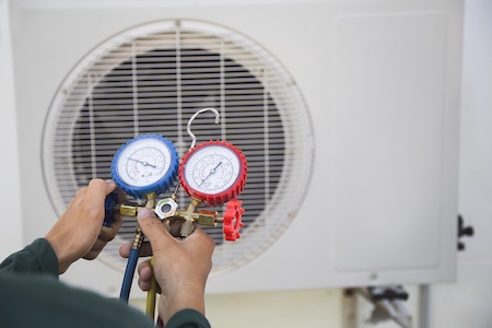 Technician performing AC tune-up in an Austin home